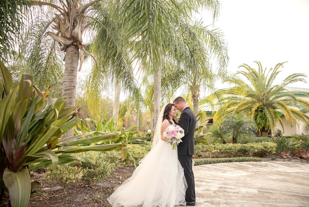 Outdoor Tropical Garden Wedding Portrait, Bride in Layered Ballgown Hayley Paige Dress with Veil and White and Pink Peony Bouquet with Greenery | Sarasota Wedding Photographer Kristen Marie Photography