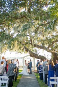 Outdoor Waterfront Wedding Ceremony Portrait with White Folding CHairs under Live Oak Tree with Spanish Moss and Hanging Hurricane Lanterns | Tampa Bay Wedding Photographer Andi Diamond Photography | Sarasota Wedding Venue Palmetto Riverside Bed and Breakfast