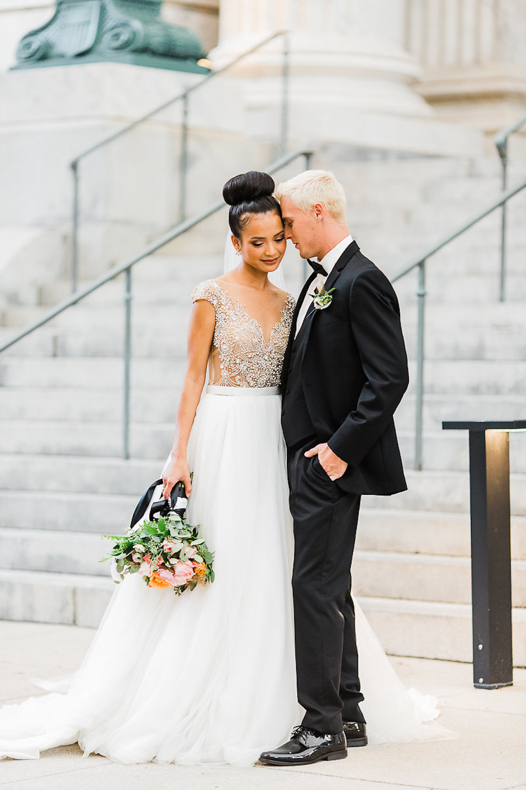 Outdoor Wedding Portrait, Bride in Ballgown Wedding Dress with Orange and Pink Floral with Greenery Bouquet with Black Ribbon, Groom in Black Tuxedo with Boutonniere | Historic Downtown Tampa Hotel Wedding Venue Le Meridien | Hair and Makeup Michele Renee The Studio