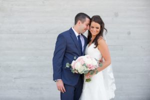 Outdoor Downtown Wedding Portrait, Bride in Sweetheart A Line Wedding Dress with Long Lace Edged Comb Veil and White and Pink Rose with Greenery Bouquet, Groom in Navy Blue Suit | Tampa Wedding Photographer Andi Diamond Photography