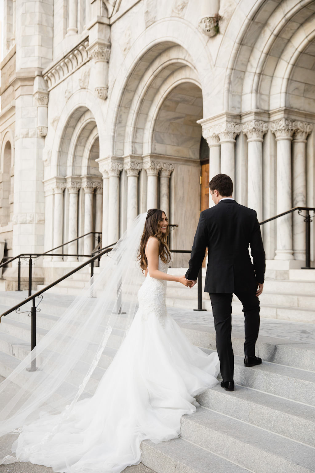 Outdoor Church Steps Wedding Portrait, Bride in Trumpet Martina Liana Dress with Long Veil | Downtown Tampa Ceremony Venue Sacred Heart Catholic Church