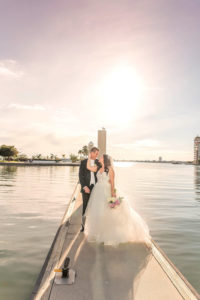 Outdoor Waterfront Marina Sunset Wedding Portrait, Bride in Layered Ballgown Hayley Paige Dress with Veil with PInk and White Peony Bouquet | Sarasota Wedding Photographer Kristen Marie Photography