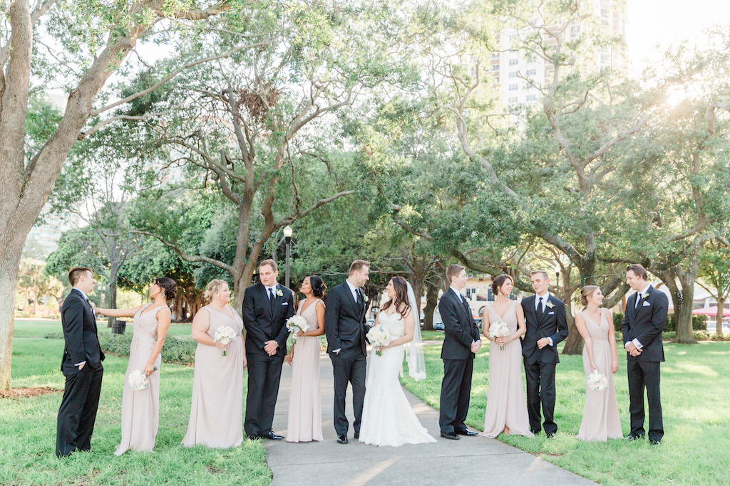 Outdoor Park Wedding Party Portrait, Bridesmaids in V Neck Tuape David's Bridal Dresses, Groomsmen in Black Suits, with White Floral and Greenery Bouquet and Boutonniere | Tampa Bay Wedding Florist Cotton and Magnolia