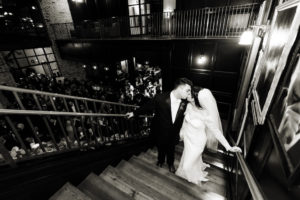 Bride and Groom Black and White Wedding Portrait on Staircase, Bride in Illusion Lace Long Sleeve Dress