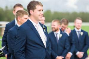 Outdoor Wedding Ceremony Portrait, Groom and Groomsmen in Navy Blue Men's Wearhouse and Joseph Abboud Suits with Ivory Ties, with Marsala Red and Greenery Boutonniere