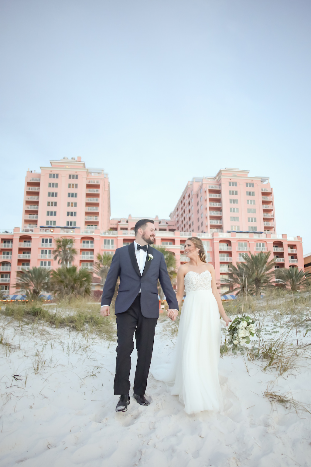 Outdoor Beach Wedding Portrait, Bride in Strapless Wtoo Bridal Dress with White Floral and Greenery Bouquet, Groom in Gray and Black Suit with Boutonniere | Tampa Bay Wedding Photographer Lifelong Studios Photography | Waterfront Hotel Venue Hyatt Regency Clearwater Beach