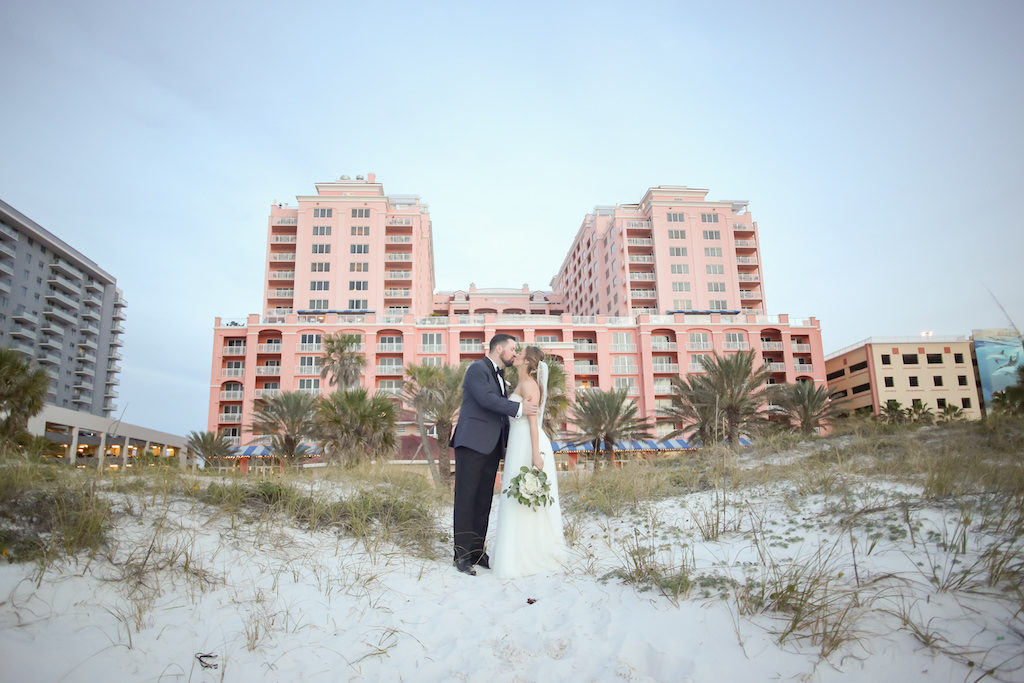 Outdoor Beach Wedding Portrait, Bride in Strapless Wtoo Bridal Dress with White Floral and Greenery Bouquet, Groom in Gray and Black Suit with Boutonniere | Tampa Bay Wedding Photographer Lifelong Studios Photography | Waterfront Hotel Venue Hyatt Regency Clearwater Beach