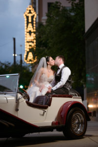 Downtown Tampa Wedding Exit Portrait in Antique Car with Tampa THeater Sign