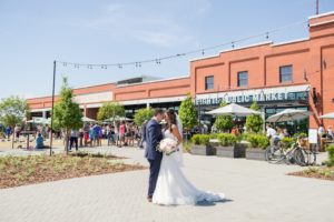 Outdoor Downtown Wedding Portrait, Bride in Sweetheart A Line Wedding Dress with Long Lace Edged Comb Veil and White and Pink Rose with Greenery Bouquet, Groom in Navy Blue Suit | Tampa Wedding Photographer Andi Diamond Photography | Armature Works Wedding