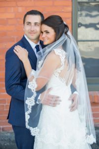 Outdoor Downtown Wedding Portrait, Bride in Open Back Lace A Line Wedding Dress with Long Lace Edged Comb Veil, Groom in Navy Blue Suit | Tampa Wedding Photographer Andi Diamond Photography
