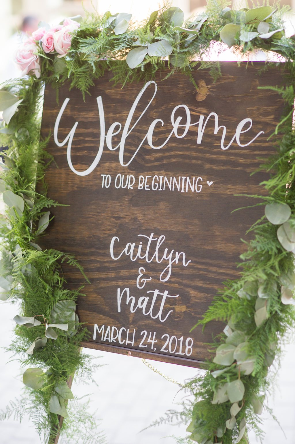Outdoor Rustic Chic Wedding Ceremony Wooden Welcome Sign with White Handpainted Script and Greenery Garland with Pink Florals