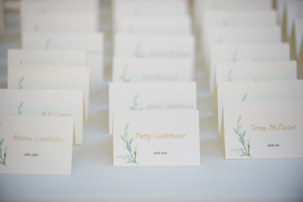 Sage Greenery Printed Wedding Escort Cards on Table with Gold Script