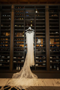 Illusion Lace Sleeve Wedding Dress and Veil on Custom Hanger in Wine Cellar