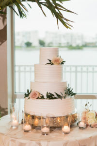 Four Tier Round White Wedding Cake with Blush Pink Rose and Greenery on Antique Silver Cake Stand, with Floating Votive Candles on Textured Blush LInen | Tampa Bay Wedding Caterer Olympia Catering