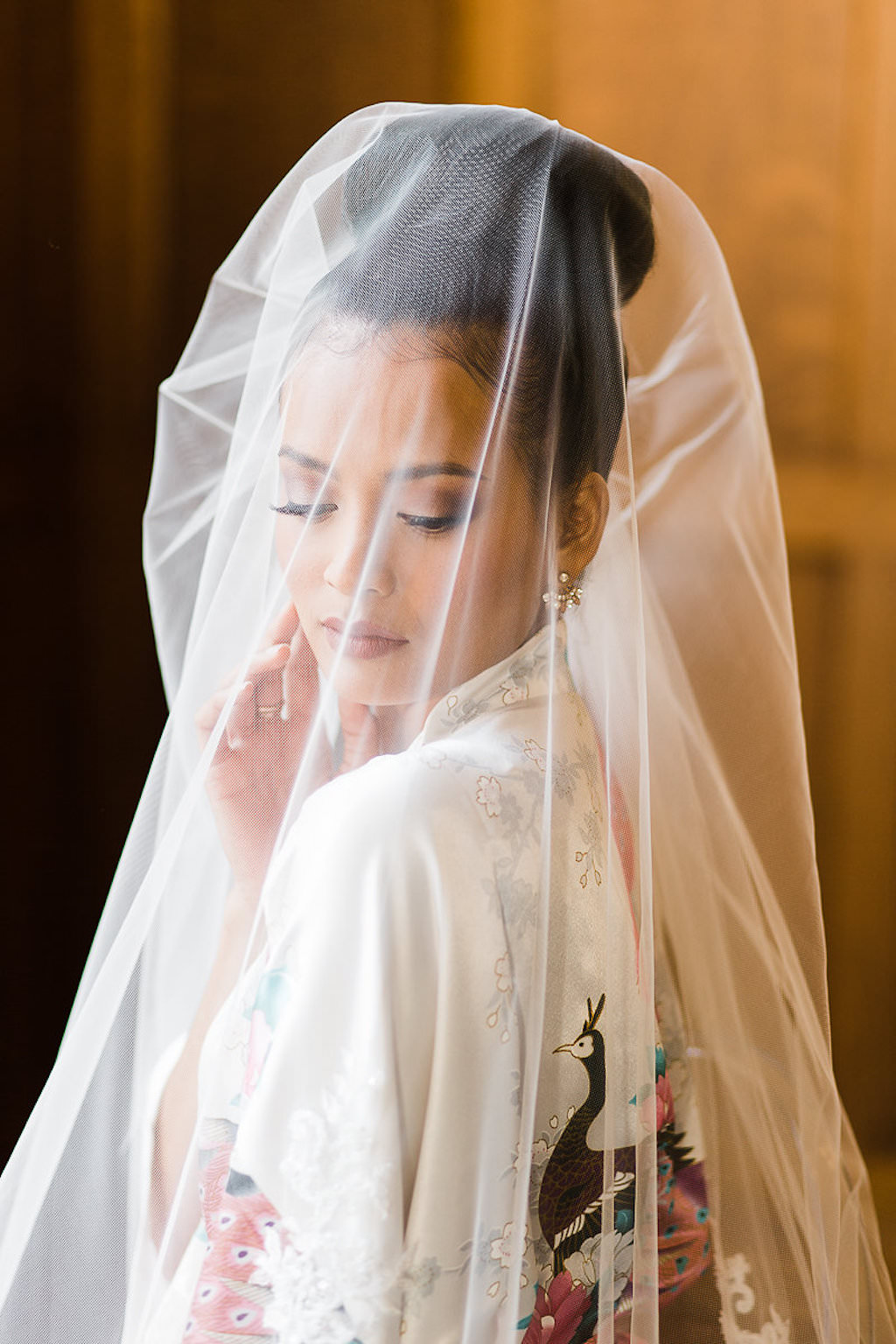 Bride Getting Ready Portrait in White Silk Kimono Robe with Stylish Bun Updo and Veil | Tampa Bay Wedding Hair and Makeup Michele Renee The Studio