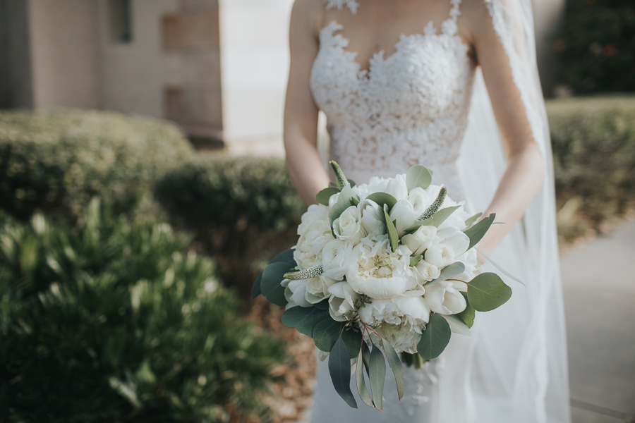 Outdoor Garden Bridal Portrait in Illusion Lace Sweetheart Column Essence of Australia Wedding Dress with White Poeny and Greenery Bouquet | Tampa Bay Wedding Photographer Brandi Image Photography