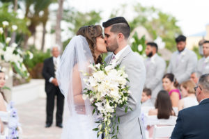Outdoor Waterfront Ceremony Wedding Portrait, Bride with White Floral and Greenery Bouquet, Groom in Light Gray Suit with Lavender Purple Tie | Hotel Reception Venue The Westin Tampa Bay
