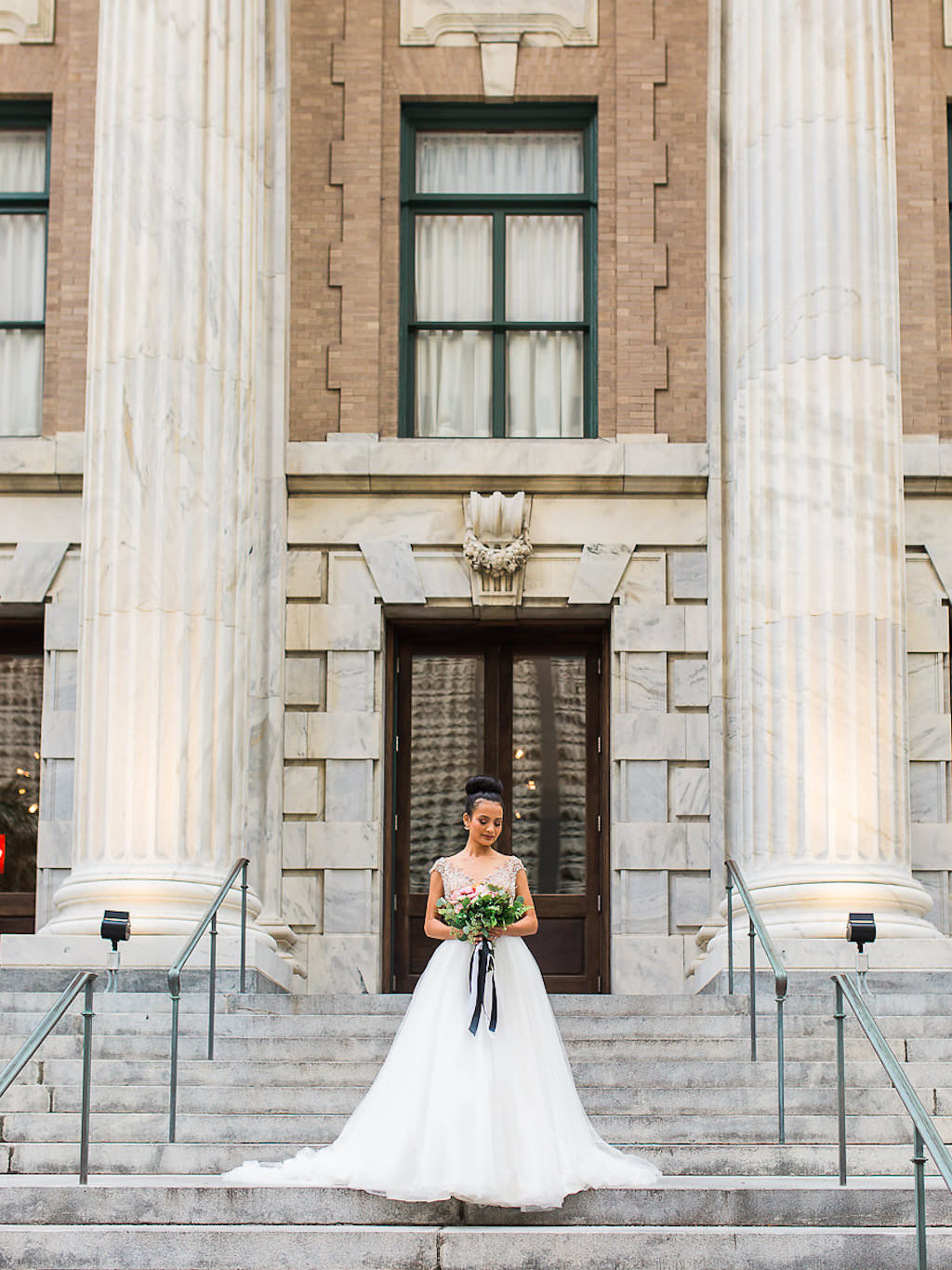 Outdoor Bridal Portrait in Ballgown Wedding Dress with Bouquet with Black Ribbon | Historic Downtown Tampa Hotel Wedding Venue Le Meridien