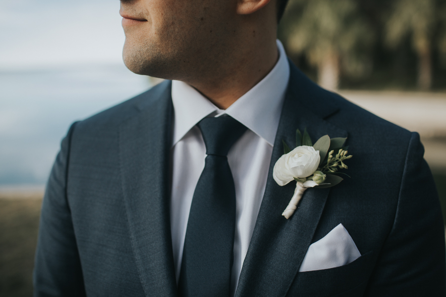 Outdoor Groom Wedding Portrait in Navy BLue Suit with White Rose and Greenery Boutonniere | Bradenton Wedding Photographer Brandi Image Photography