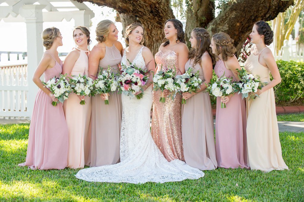 Outdoor Waterfront Bridal Party Portrait, Bride in V Neck Illusion Lace A Line Paloma Blanca Wedding Dress, Maid of Honor in Rose Gold Strapless Sequin Dress, Bridesmaids in Mismatched Beige, Blush Pink, and Peach Azazie Dresses with White, Burgundy, Anemone and Natural Greenery Bouquet | Sarasota Wedding Photographer Andi Diamond Photography | Tampa Bay Hair and Makeup Femme Akoi Beauty Studio