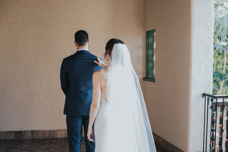 Outdoor Courtyard First Look Portrait, Bride with Long Comb Veil, Groom in Navy Blue Suit | Sarasota Wedding Photographer Brandi Image Photography