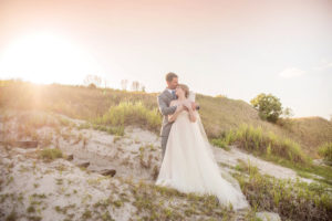 Outdoor Florida Golf Course Bride and Groom Portrait, Bride Wearing V-Neck Plunging Neckline Floral Lace Overlay and Blush Pink Lining A-Line Tulle Skirt Wedding Dress, Braided Updo and Floor Length Veil, Groom Wearing Light Grey Suit and Dusty Blue Tie | Marry Me Tampa Bay Photographer Kristen Marie Photography | Marry Me Tampa Bay Hair and Makeup Destiny and Light Hair and Makeup Group