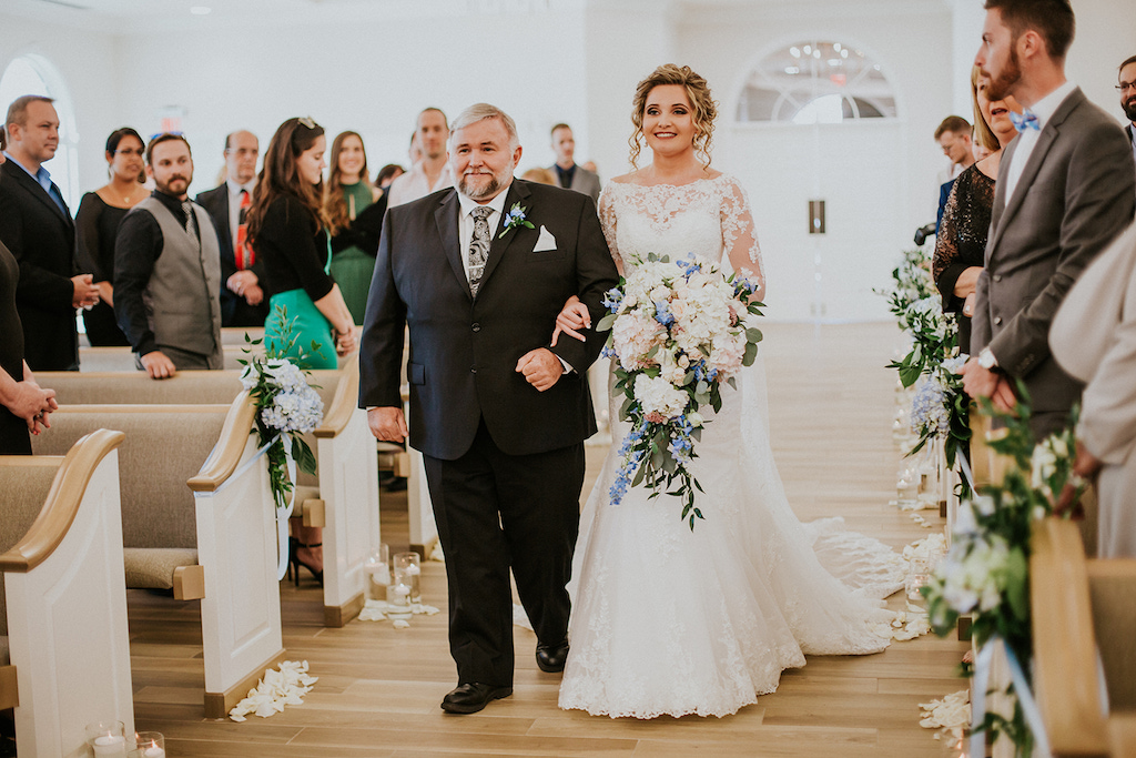 Bride Walking Down the Aisle with Father Ceremony Portrait, with White Rose, Blush Pink, Blue Flowers and Greenery Bouquet | St Petersburg Venue First United Methodist Church | Safety Harbor Wedding Venue Harborside Chapel