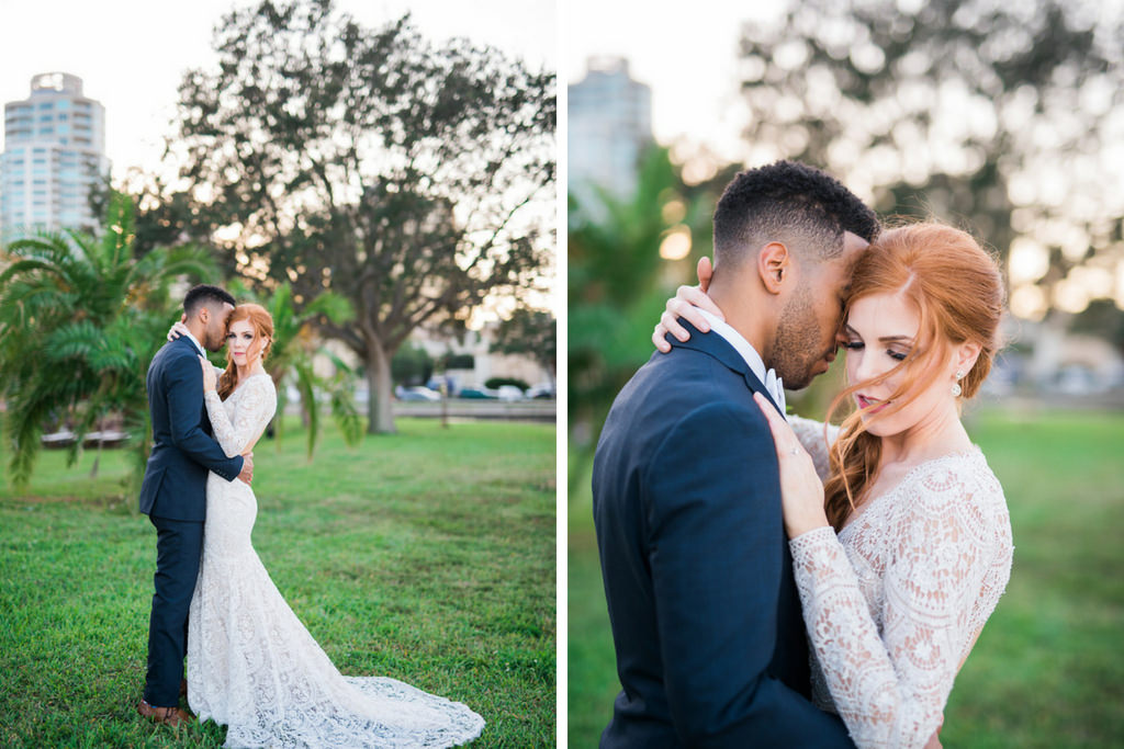 Outdoor Off-White Lace Long Sleeve Peek-A-Boo Back Vintage Inspired Bridal Portrait, with Blush Pink Roses and Greenery Organic Bouquet and Groom Wearing Navy Blue Tuxedo, Bow Tie and Organic Boutonniere | Downtown St. Pete Wedding Photographer Kera Photography