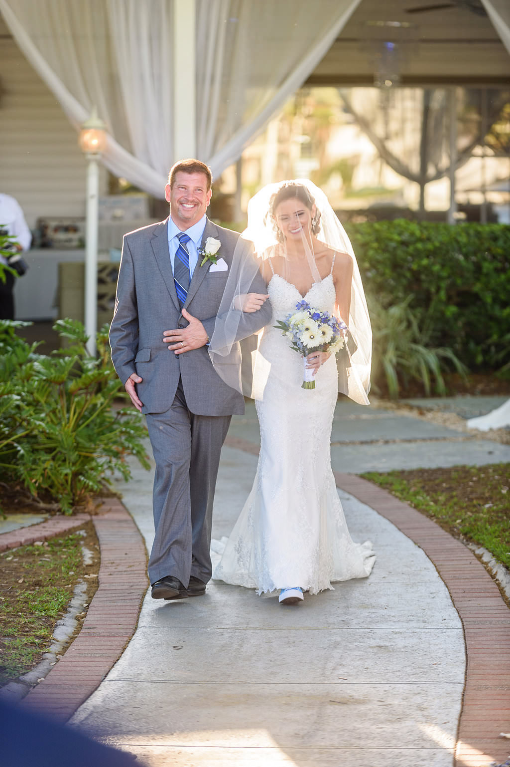 Bride and Father Wedding Ceremony Portrait Walking Down the Aisle at Davis Islands Wedding Venue Davis Islands Garden Club, Bride Wearing Strappy White Wedding Dress Holding White and Blue Floral Bouquet | Purple, Ivory and Lilac Roses Bridal Wedding Bouquet | Tampa Wedding Photographer Marc Edwards Photographs