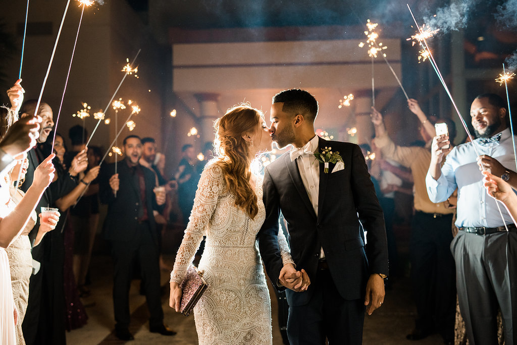 Bride and Groom Wedding Exit Portrait with Sparklers, Groom in Black Tux with Greenery Boutonniere and White Bowtie, Bride in Vintage Long Sleeve Lace Wedding Dress | St. Pete Wedding Photographer Kera Photography