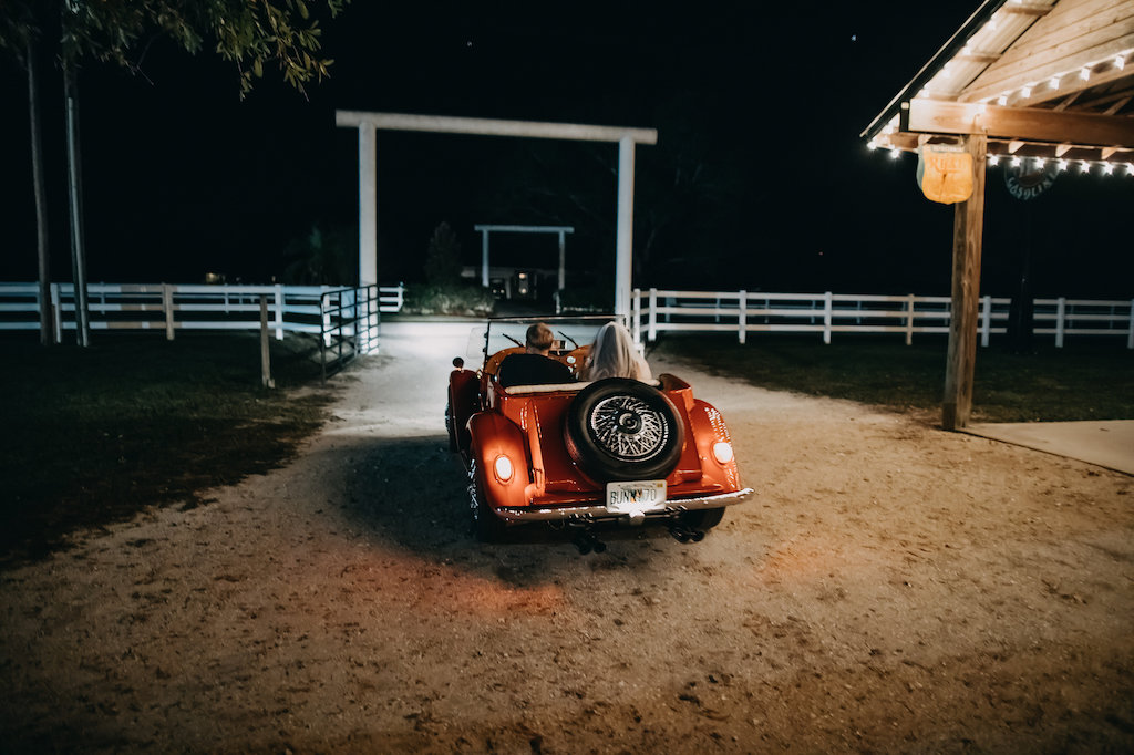Outdoor Bride and Groom Wedding Exit in Vintage Red Car | Tampa Bay Wedding Photographer Rad Red Creative