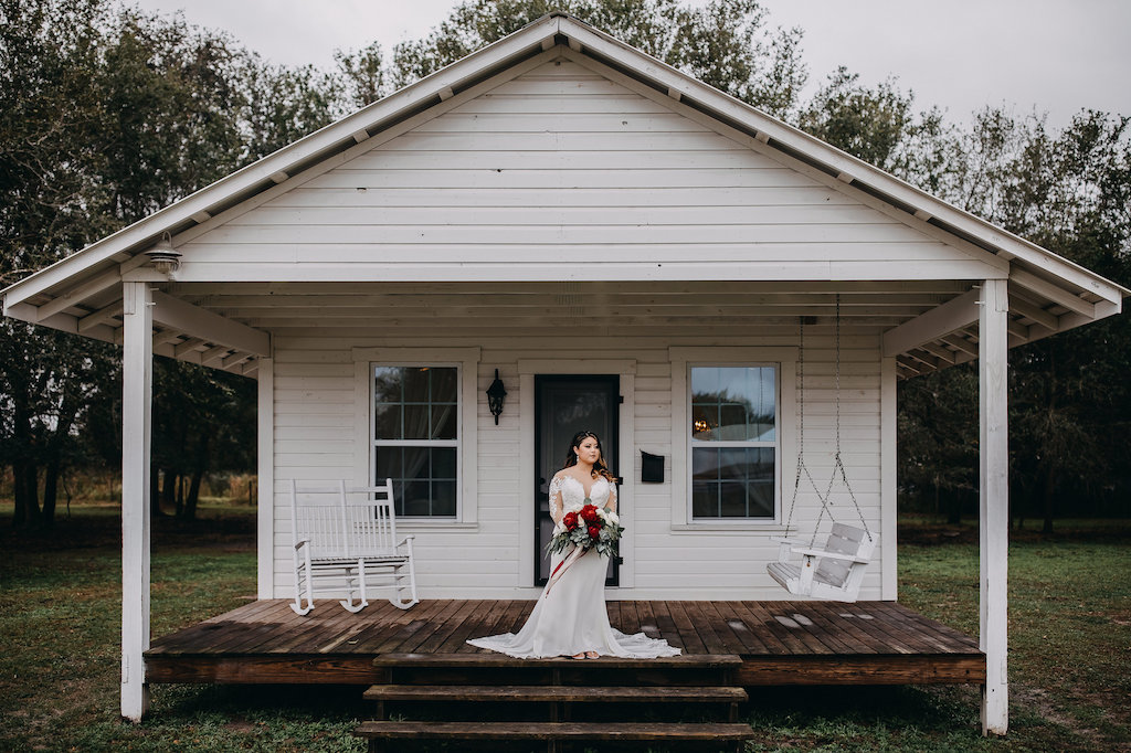 Outdoor Bride Wedding Portrait, Bride in White Lace Long Sleeve David's Bridal Wedding Dress, and Red, White and Greenery Bouquet | Tampa Bay Wedding Photographer Rad Red Creative | Lithia Rustic Wedding Venue Southern Grace