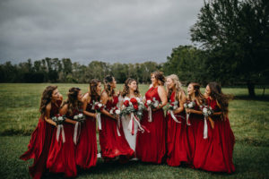 Outdoor Wedding Bridal Party Portrait, Bride in White Lace Long Sleeve David's Bridal Wedding Dress, Bridesmaids in Burgundy Red Dresses, with Red Peonies, White Roses and Greenery Bouquets | Tampa Bay Wedding Photographer Rad Red Creative | Lithia Rustic Wedding Venue Southern Grace