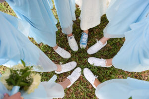 Bridal Party Bridesmaids with White Sneakers on Grass Wearing Light Blue David's Bridal Bridesmaid Dresses and Bride in White Wedding Dress and Light Blue Converse Sneakers | Tampa Bay Photographer Marc Edwards Photographs