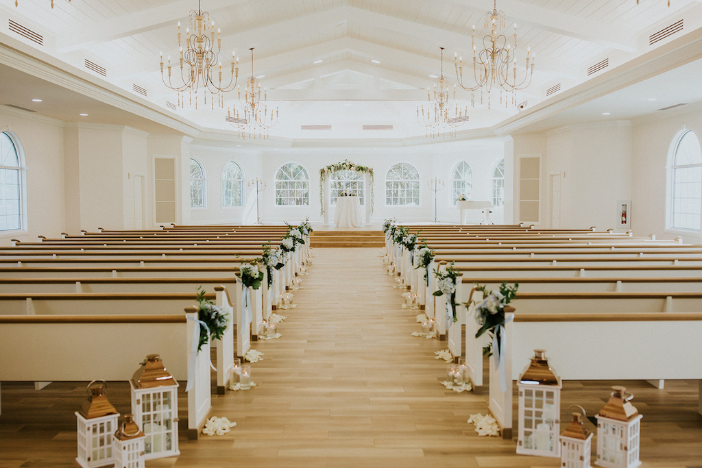 White Ceremony Decor with Lantern Aisle Decor and Greenery | Safety Harbor Wedding Ceremony Venue Harborside Chapel