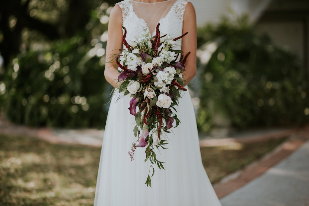 Outdoor Bridal Portrait Boho Lace V-Neck Illusion A-Line Wtoo Wedding Dress and Cascading White and Burgundy Flowers and Greenery Bouquet | Tampa Bay Wedding Venue Davis Islands Garden Club