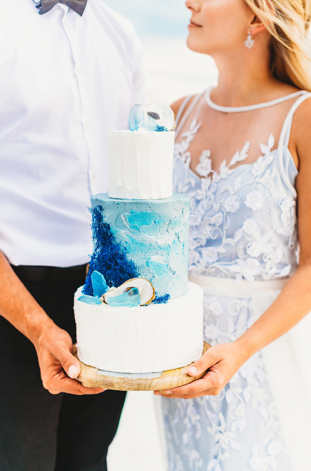 Coastal, Redington Shores Bride and Groom Wedding Portrait Holding Three Tier White and Blue Wedding Cake