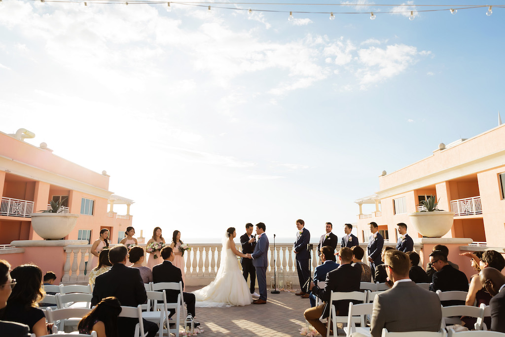 Waterfront Hotel Rooftop Elegant Wedding Ceremony Portrait with White Folding Chairs | Venue Hyatt Regency Clearwater Beach