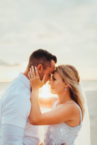 Coastal, Redington Beach Waterfront Sunset Bride and Groom Wedding Portrait, Bride in Sleeveless Illusion Neckline Floral Overlay and Light Blue Wedding Dress with Tulle Skirt and Veil