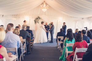 Tampa Wedding Venue Safety Harbor Bride and Groom Ceremony Portrait, White and Blush Linen Drapery, Chandelier and Pink, White and Greenery Floral Bouquet | Tampa Wedding Photographer Luxe Light Photography