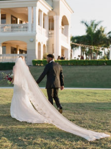 Outdoor Wedding Ceremony Exit Portrait, Bride in Illusion Spaghetti Strap Illusion Lowback Lace Dress and Cathedral Long Veil, Groom in Black Tuxedo | Clearwater Beach Wedding Venue Feather Sound Country Club