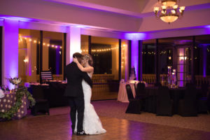 Indoor Ballroom Wedding Reception Bride and Groom Dancing with String Lighting | Clearwater Wedding Venue Feather Sound Country Club