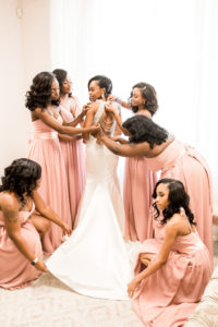 Bride and Bridesmaids Getting Ready Portrait Illusion V-neck Rhinestone Beaded Bodice and Tank Top Strap Wedding Dress with Keyhole Back, Bridesmaids in Blush Pink Mix and Match Dresses | Tampa Wedding Dress Shop Truly Forever Bridal