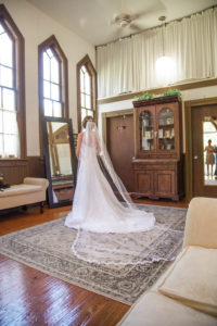 Bride Getting Ready Portrait in White A-Line Strapless Sweetheart Lace Wedding Dress and Cathedral Length Veil
