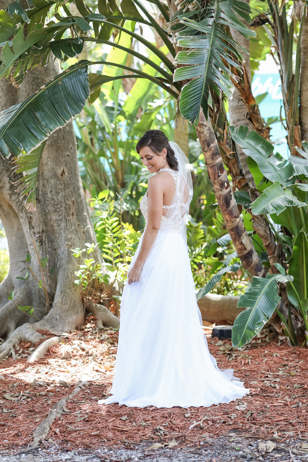 Outdoor Bridal Portrait A-Line Scoop Neck Nude Rhinestone Bodice and White Chiffon Floor Length Wedding Dress with Beaded Keyhole Back and Veil and Half Up Hairdo | Tampa Bay Wedding Photographer Lifelong Photography Studios | Tampa Bay Wedding Hair and Makeup Michele Renee the Studio