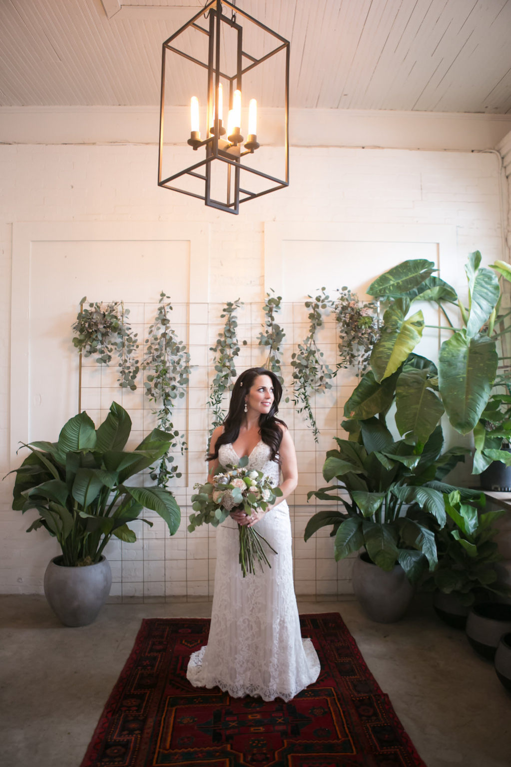 Indoor Bride Wedding Portrait, V-Neck Lace Floor Length Wedding Dress, Curled Hair Down with Jeweled Hair Clip with Pink and Ivory Floral and Greenery Bouquet | Tampa Bay Wedding Photographer Carrie Wildes Photography | Tampa Heights Wedding Venue Fancy Free Nursery