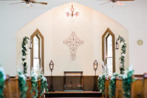Dunedin Wedding Ceremony Venue Andrew's Memorial Chapel with Greenery and White Floral Ceremony and Pew Decor