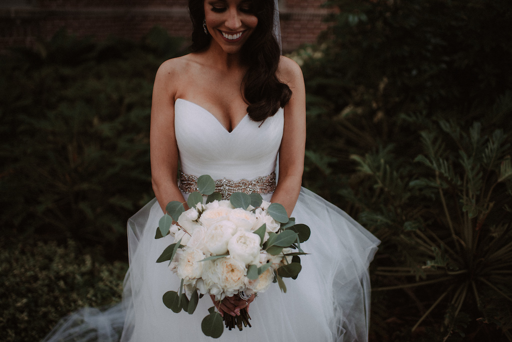 Bride Wedding Portrait Holding Ivory Rose, Peonies and Silver Dollar Eucalyptus Bouquet Wearing White Sweetheart Tulle Skirt Wedding Dress with Rhinestone Belt | Bridal Shop The Bride Tampa