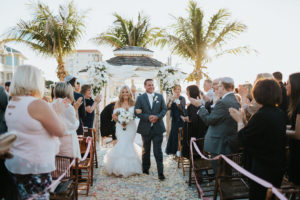 Outdoor Beach Wedding Ceremony Exit Bride and Groom at Gazebo with Birchwood Arch, White Draping and White Florals | Waterfront Venue Isla Del Sol Yacht and Country Club