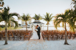 Outdoor Beach Wedding Ceremony at Gazebo with Birchwood Arch, White Draping and White Florals | Waterfront Venue Isla Del Sol Yacht and Country Club